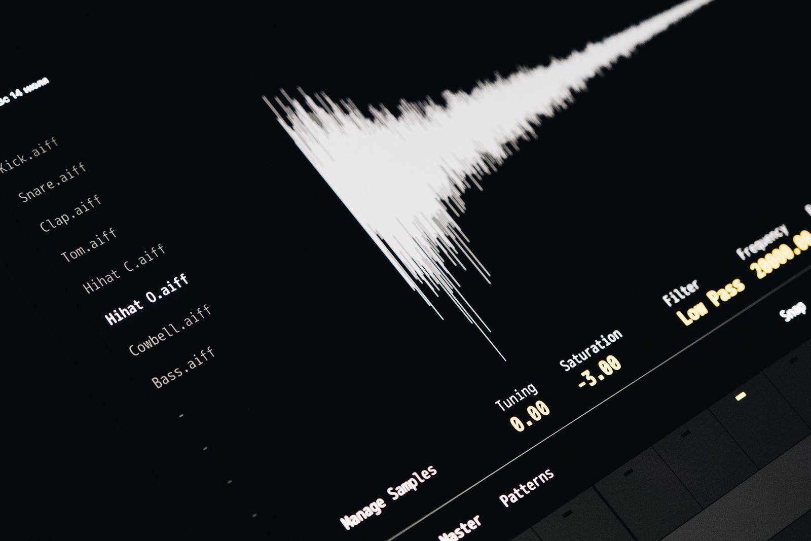 Close-up of an audio editing interface on a screen showing sound waveforms and audio file names.